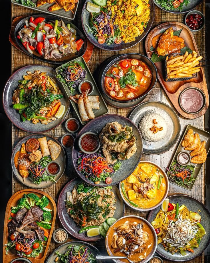 A colourful overhead spread of Malaysian dishes and shared plates