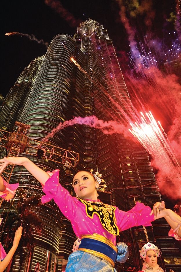 Malaysian cultural performance and fireworks beneath the Petronas Twin Towers
